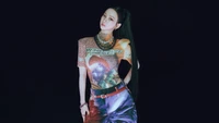 Karina from Aespa showcases a bold fashion statement, blending streetwear with artistic graphics against a dark backdrop.