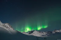 Enchanting Aurora Over Snowy Mountains in Alaska