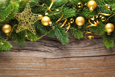 Festive Christmas Decorations with Golden Ornaments and Evergreen Branches on Rustic Wood.