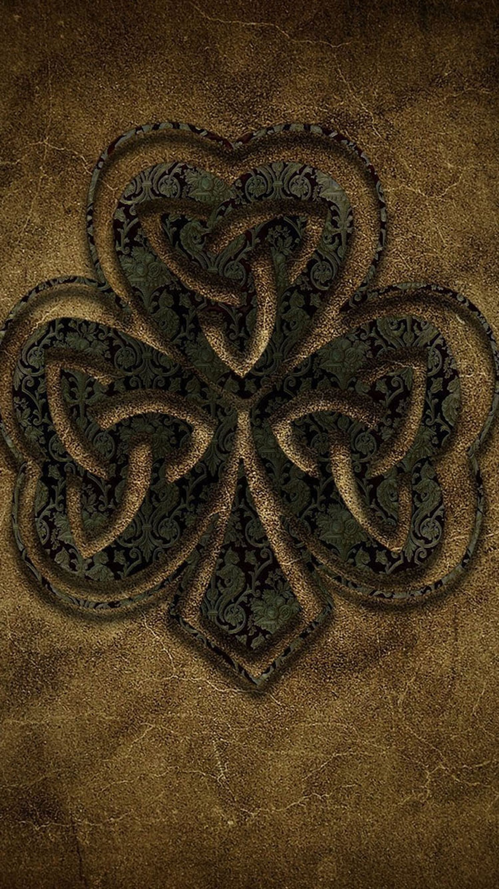 A close up of a four leaf clover on a brown background (leaf, logo)