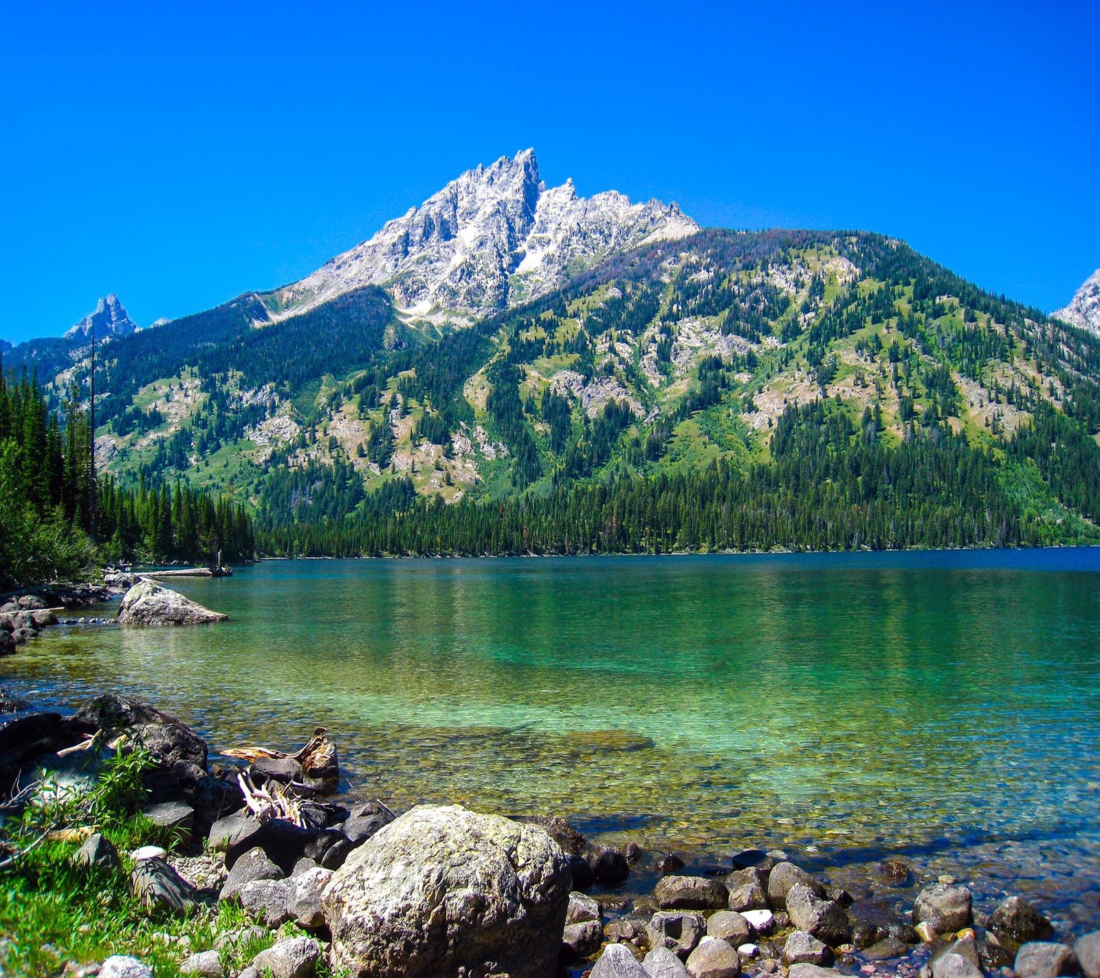 Mountains are in the background of a lake and a mountain (beautiful, cute, look, nice)