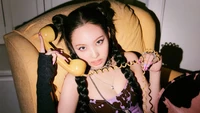 Nayeon from TWICE poses confidently with a vintage yellow telephone, showcasing a bold and stylish solo concept.