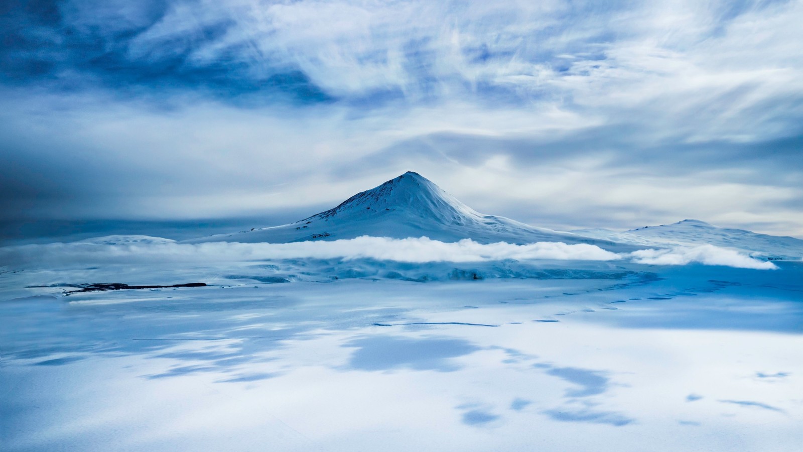 A view of a mountain with a cloud in the sky (volcano, mountain, cloud, arctic, day)