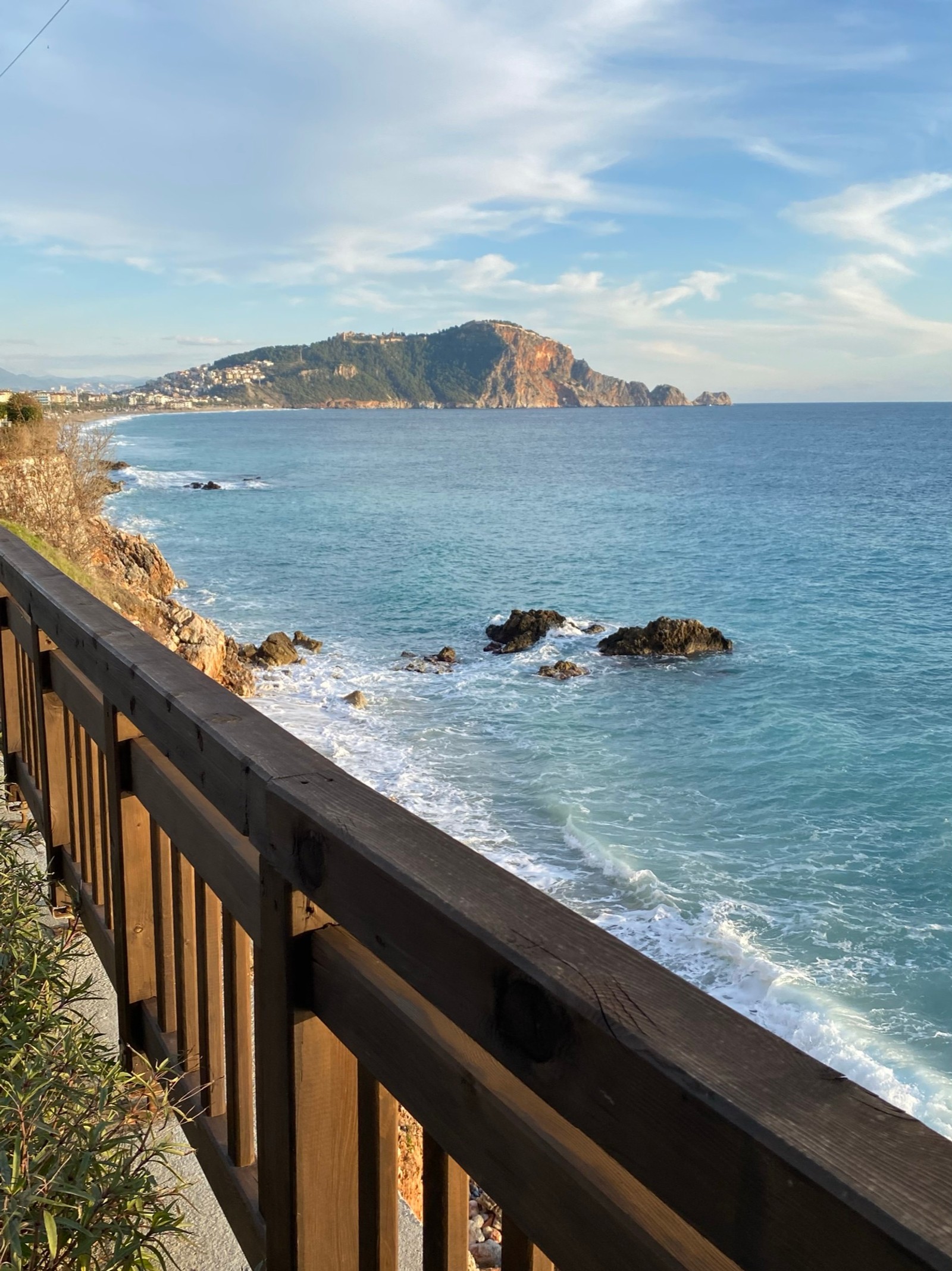 There is a man that is standing on a rail by the water (kleopatra beach, coast, water, cloud, water resources)