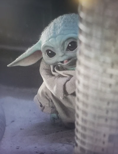 Adorable Baby Yoda Peeking from Behind a Barrier