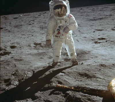 An astronaut exploring the lunar surface, casting a long shadow against the moon's rugged terrain.