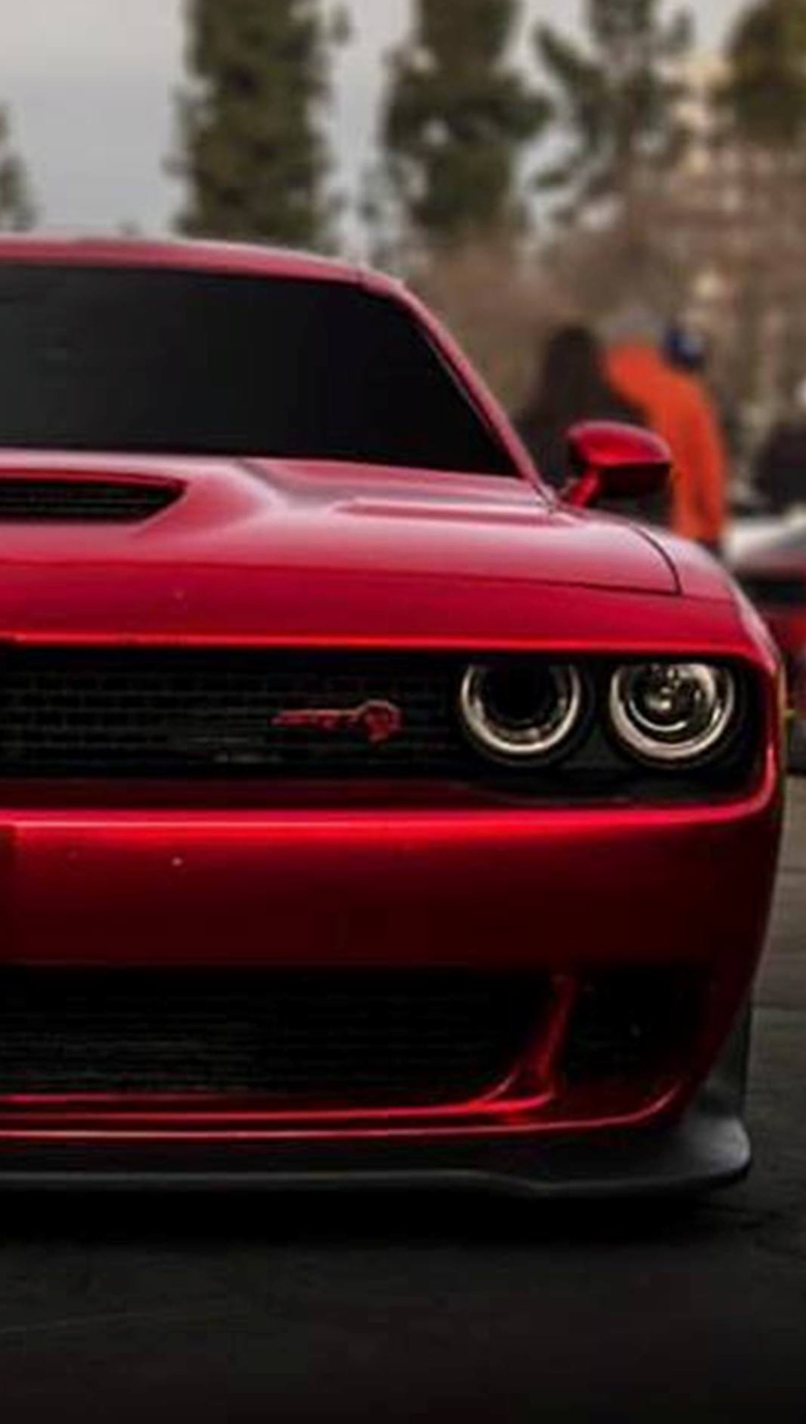 A close up of a red dodge car with a hood on (car, dodge, muscle, srt)