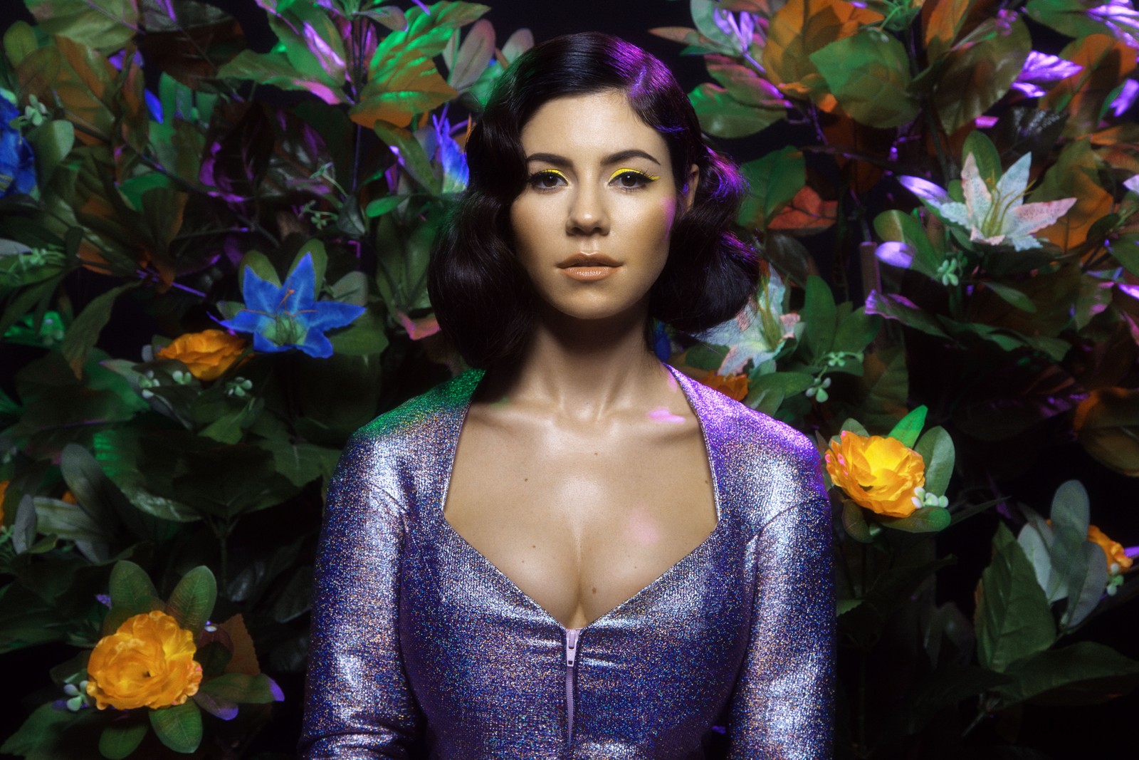 A close up of a woman in a purple dress standing in front of flowers (marina, purple, beauty, violet, plant)