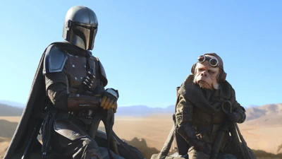 Mandalorian and Alien Companion in a Desert Landscape