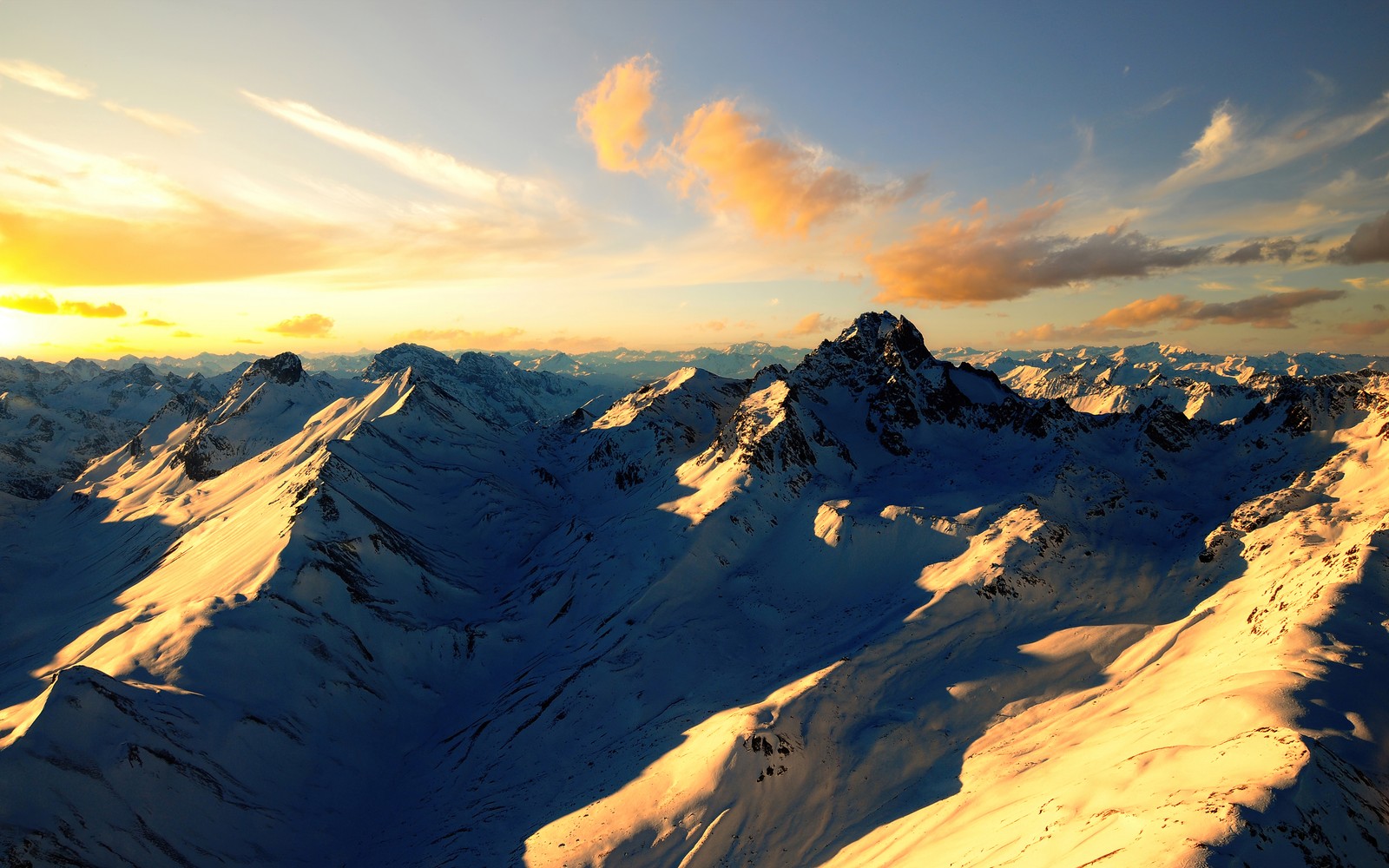 Arafed view of a mountain range with a sunset in the background (swiss alps, alps mountains, aerial view, morning, sunny day)