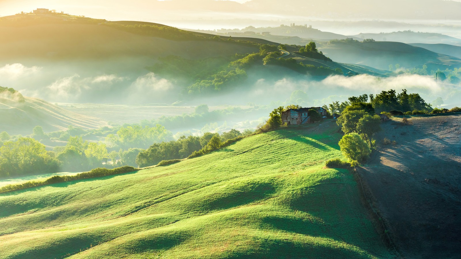 A view of a green hillside with a house on top of it (mountain, green, grass, field, scenery)