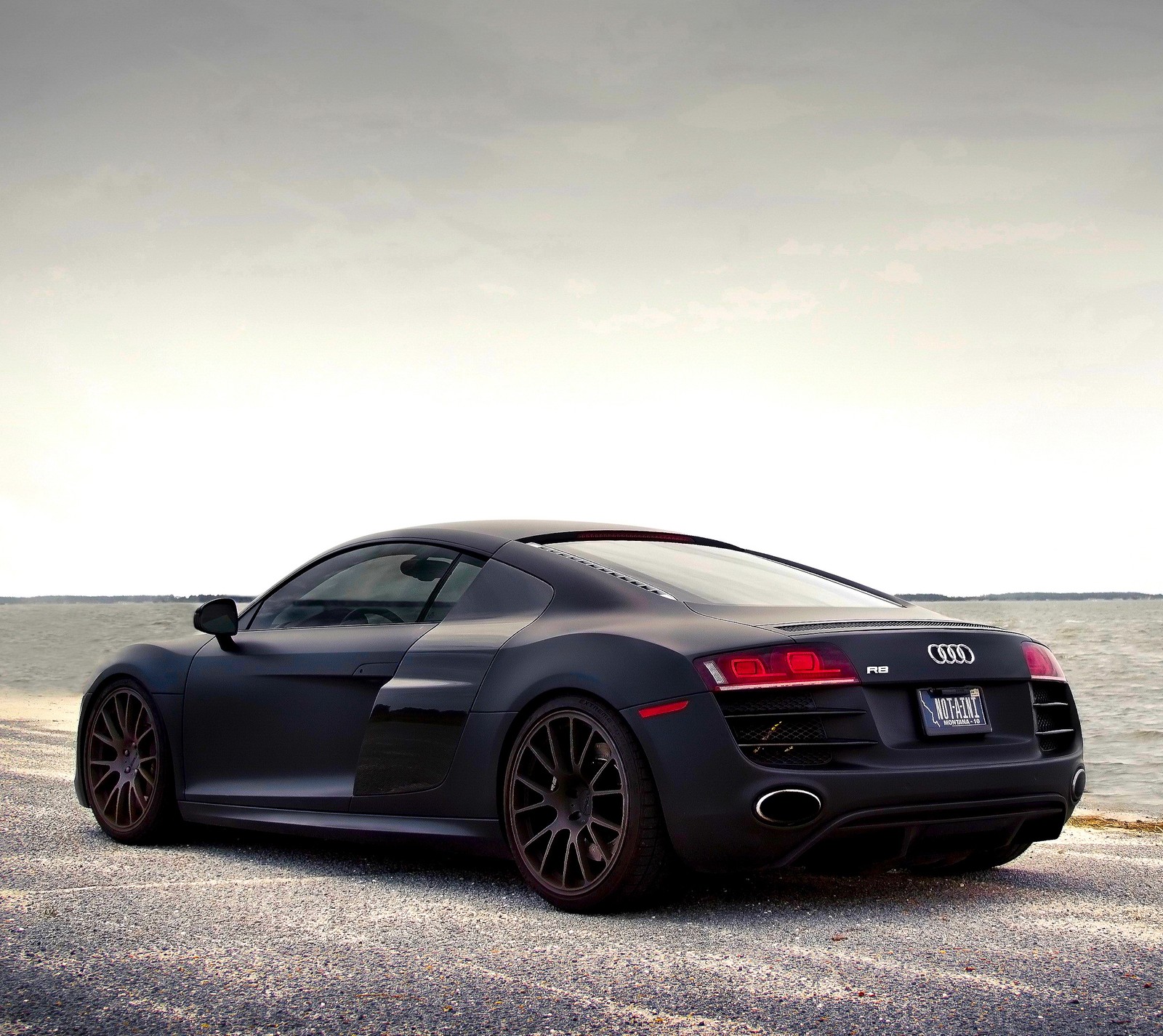 Audi r8 v10 coupe on the beach with the ocean in the background (audi r8, black, cars, hd, matt)