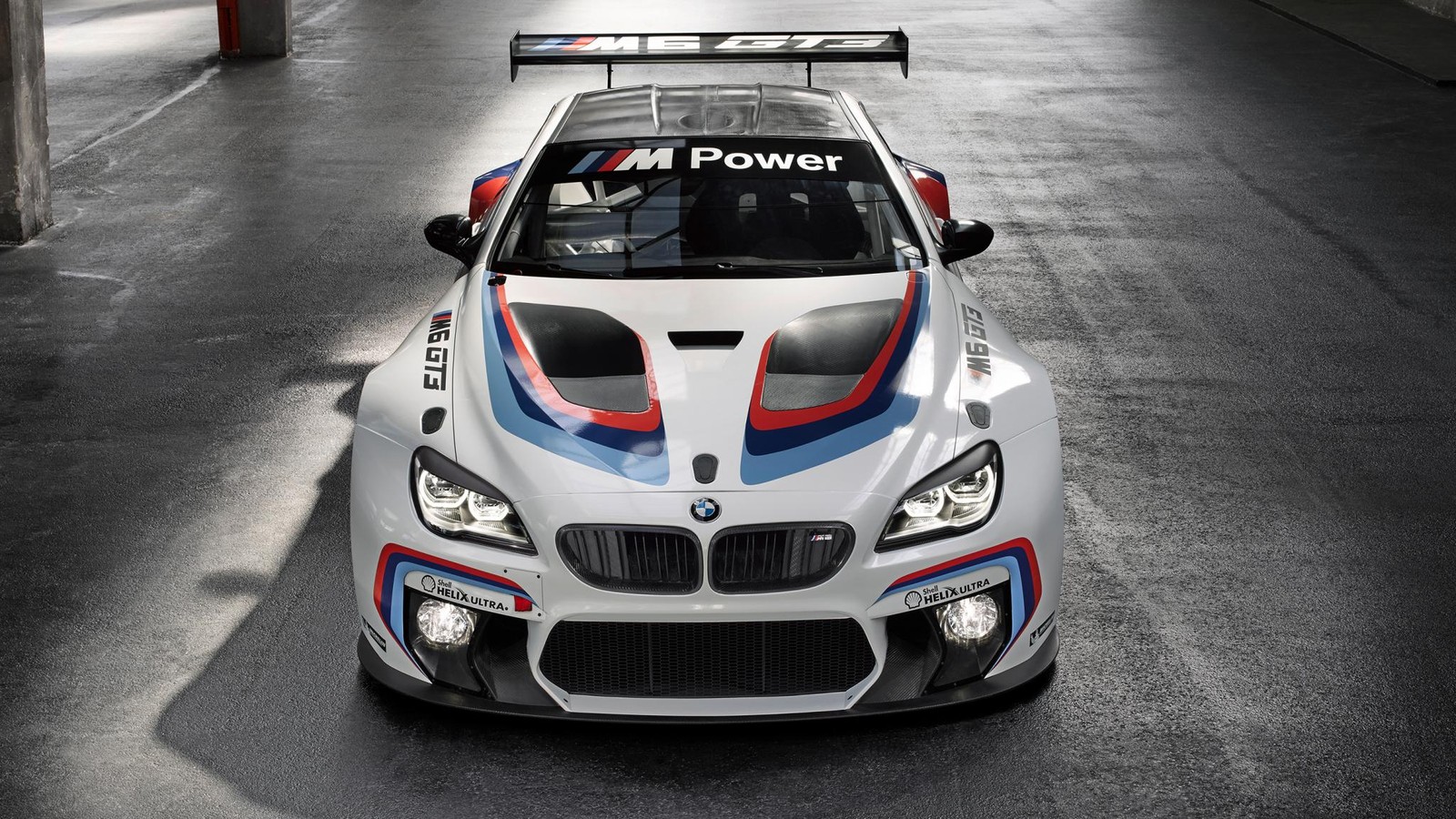 Coche de motorsport bmw en un garaje con un coche de policía en el techo (coche, bmw, coche deportivo, carreras de autos deportivos, gt 3)