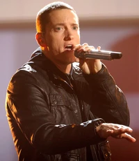 Eminem performing passionately with a microphone, showcasing his talent as a hip hop artist.