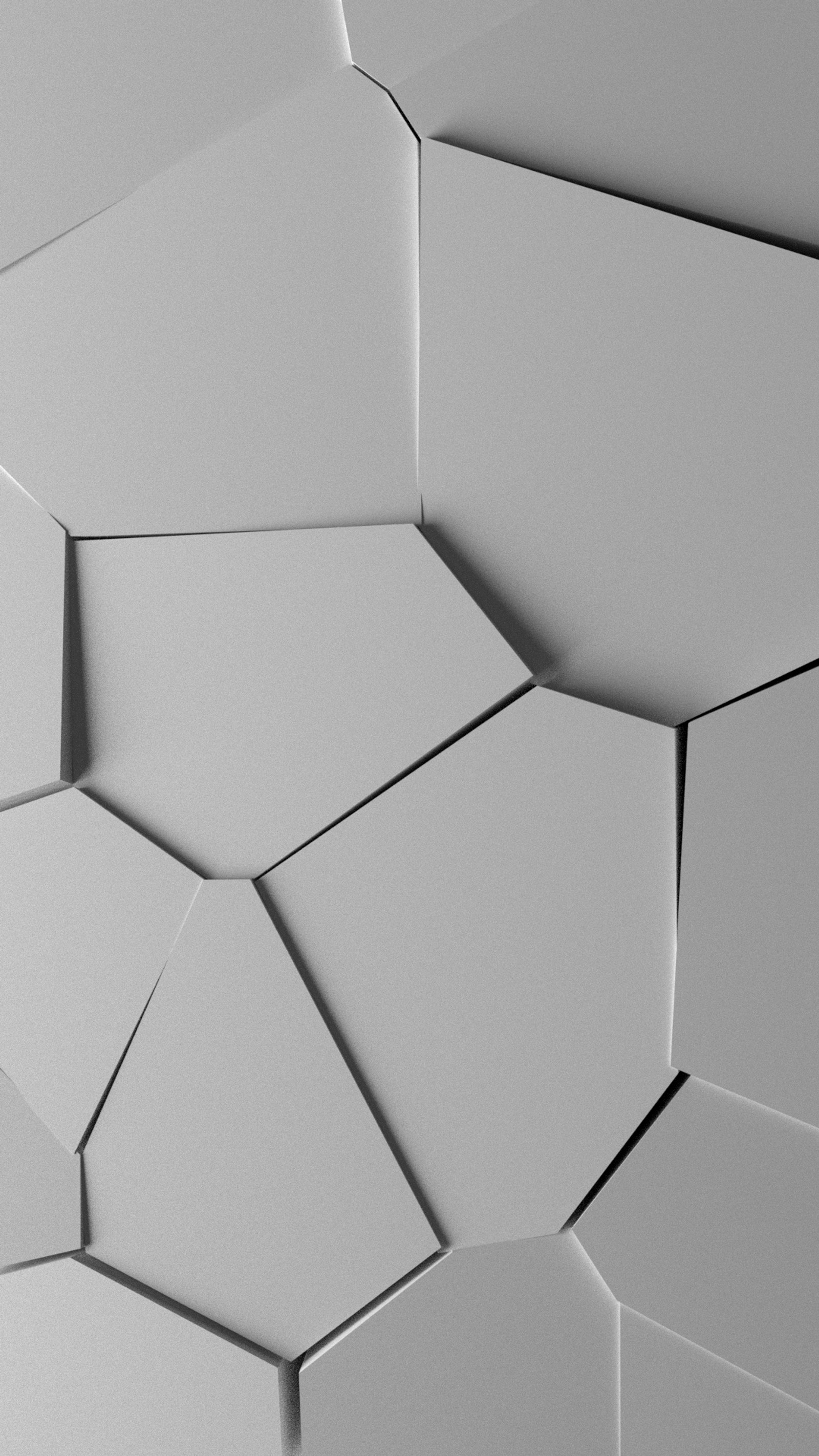 A close up of a bunch of white hexagons on a wall (broken, burst, cracked, pieces, shattered)