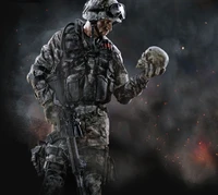 A soldier in tactical gear contemplates a skull amidst a smoky, dark background, symbolizing the weight of conflict and mortality.