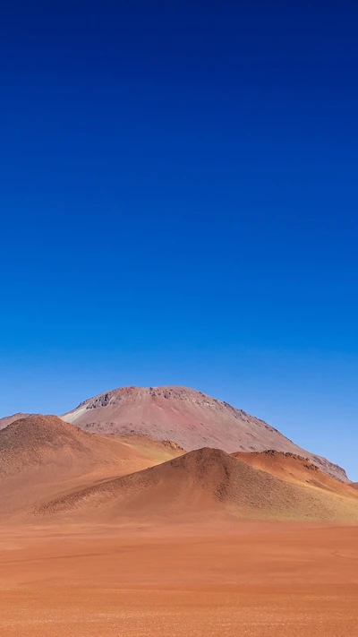 Majestic Desert Landscape with Colorful Mountains under a Clear Blue Sky