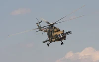 Military Helicopter in Flight Against a Blue Sky