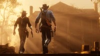 Two gunslingers approach a sunlit, weathered building, embodying the spirit of adventure in an iconic western setting.