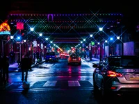 Vibrant City Night: Illuminated Streets with Automotive Glow