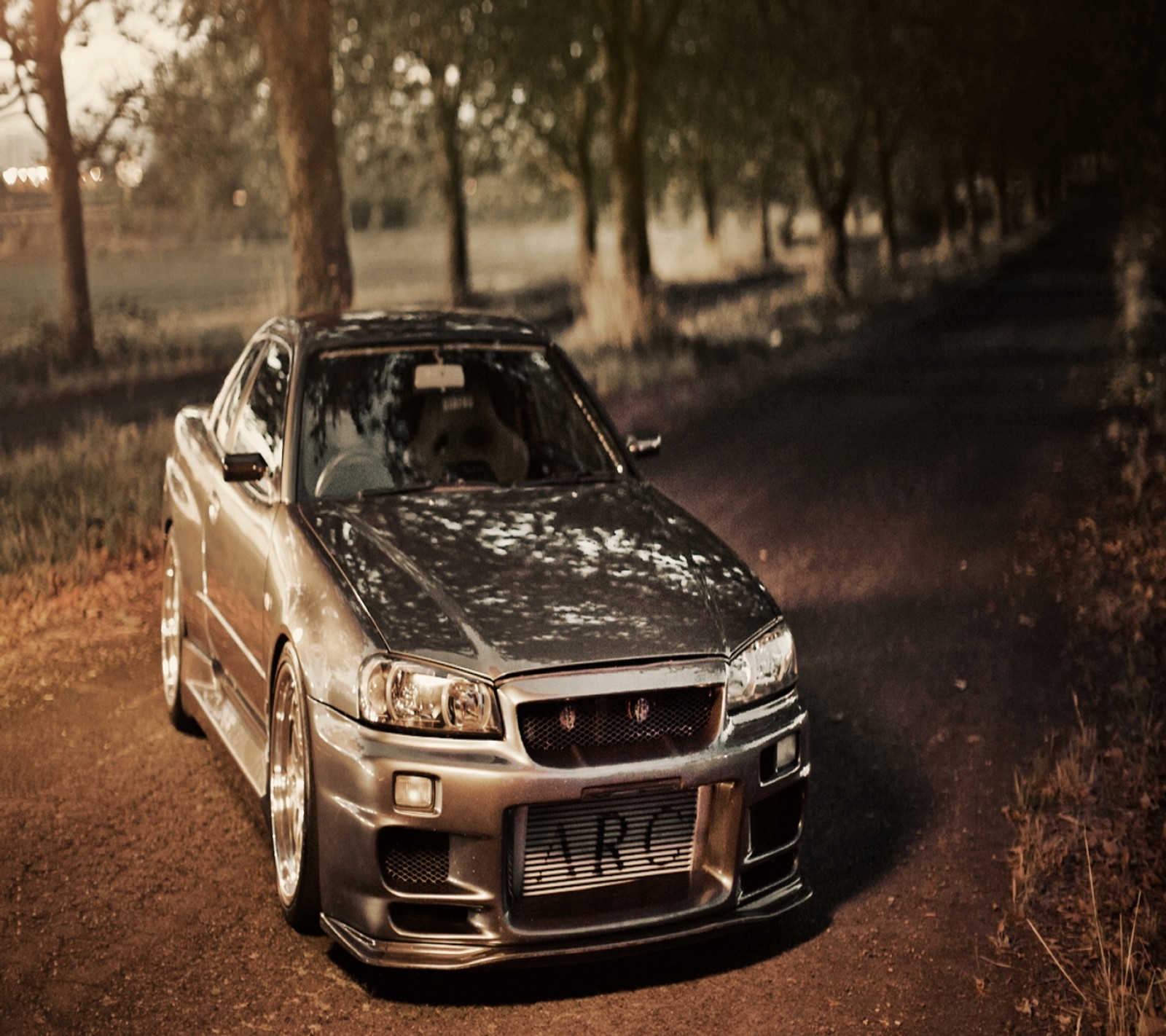 Arafed car parked on a dirt road in a wooded area (auto, car, nice, vehicle)