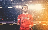 Mohamed Salah celebrating a goal for Liverpool in a snowy match at Anfield.