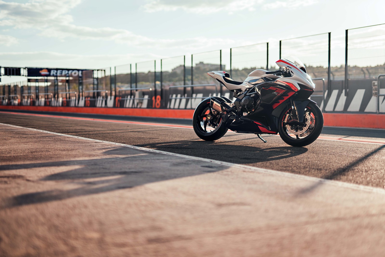 There is a motorcycle that is parked on the side of the road (mv agusta f3 rr, 8k, sports bikes, race track, 2022)