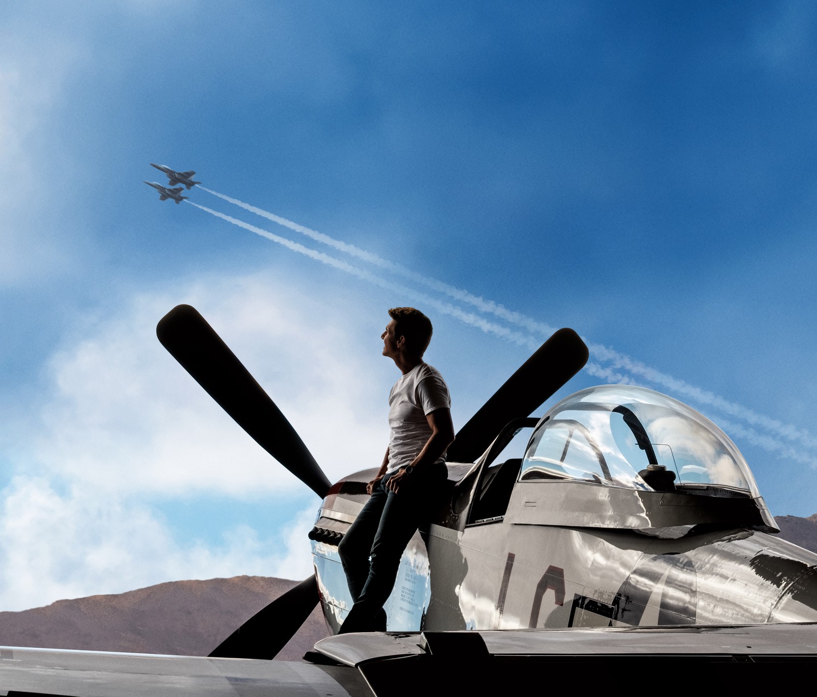 There is a man standing on the wing of a plane (top gun maverick, 8k, tom cruise, action movies, 2020 movies)