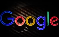 Vibrant Google Logo Illuminated Against a Dark Background