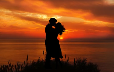 Romantic Silhouette of a Couple Kissing at Sunset Over the Ocean