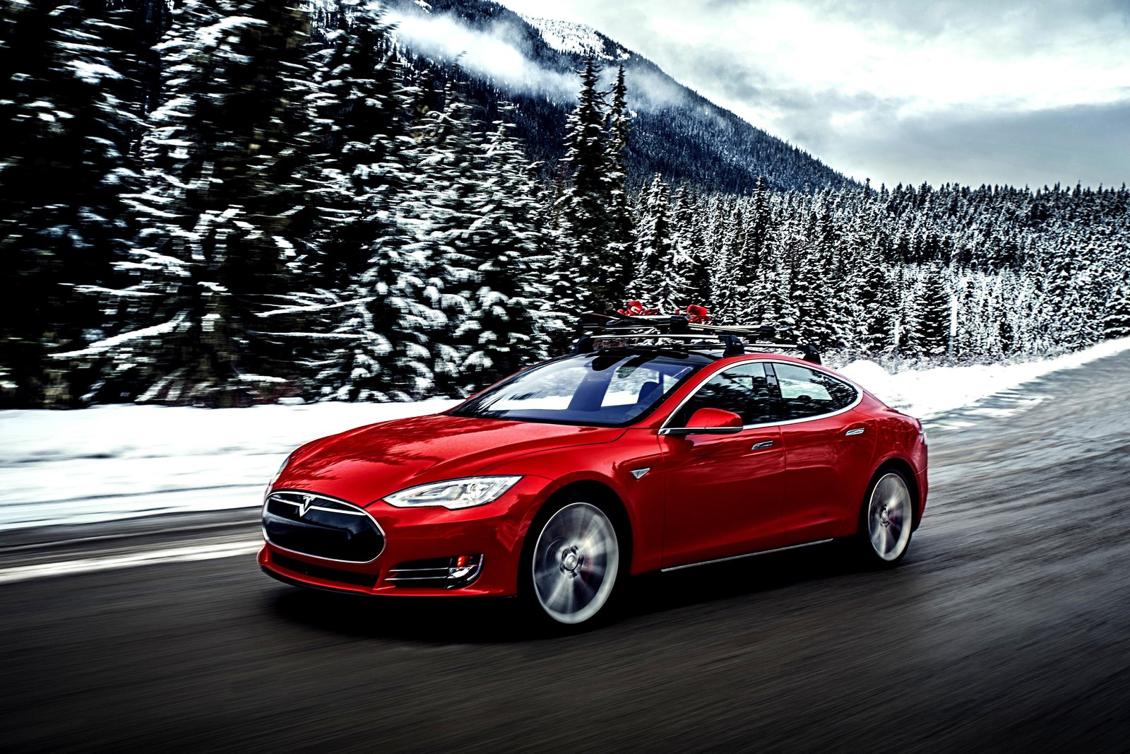 Un tesla model s rojo conduciendo por un camino nevado (coche deportivo, coche, coche de lujo, coche familiar, coche eléctrico)