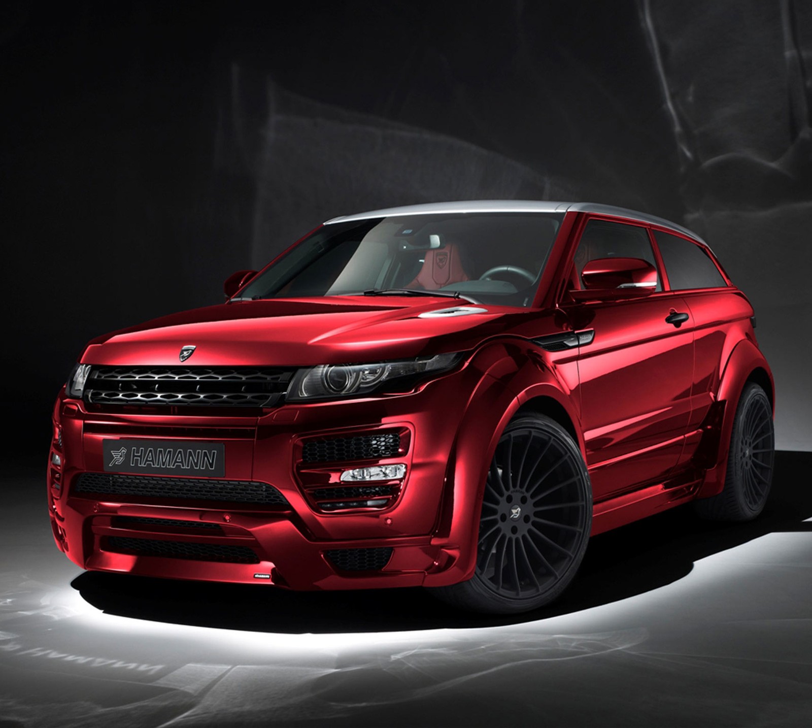 A red range rover parked in a dark room with a light on (evogue, range rover, s3)