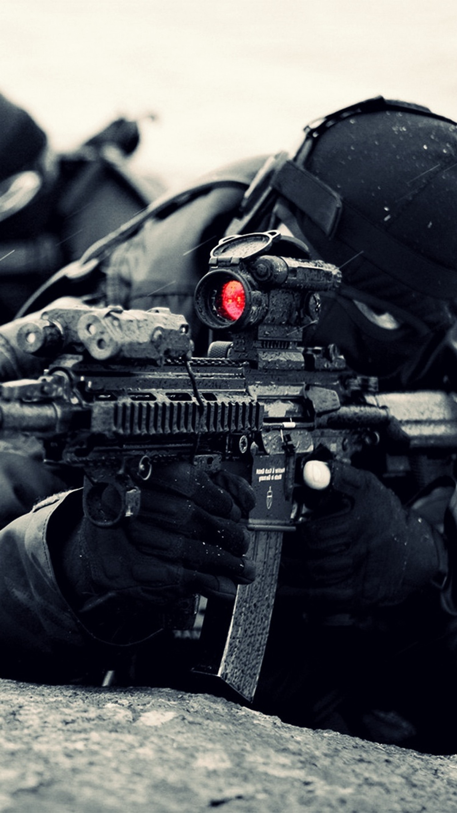 Arafed soldier with a rifle and a helmet on laying on the ground (army, awesome, cool, gun, nice)