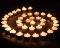 Spiral of Illuminated Wax Candles in Dark Serenity