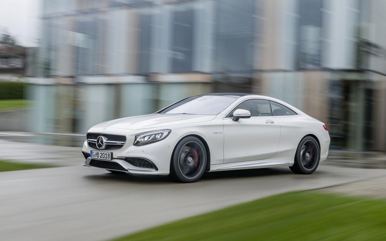 The mercedes cla coupe is driving on a city street (coupe, mercedes, rim, mercedes benz, automotive design)