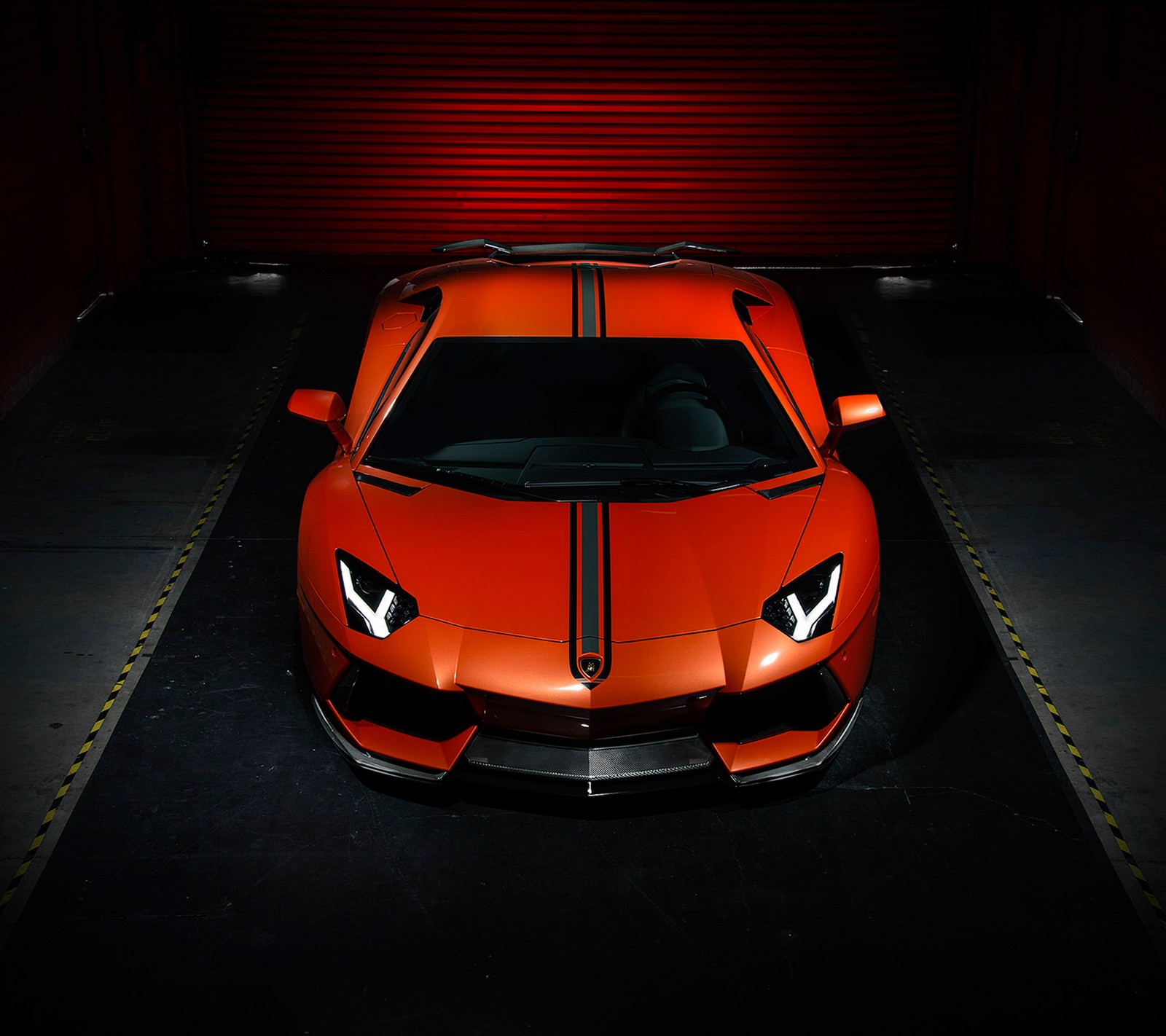 A close up of a red sports car parked in a garage (garage, lamborghini aventador, orange)