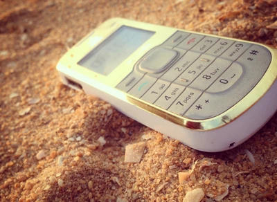 Nokia Phone Resting on Sandy Ground