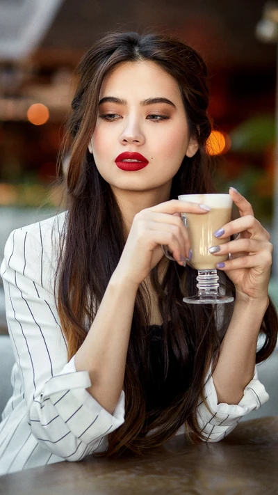 Beautiful Girl Enjoying Hot Chocolate in a Cozy Cafe