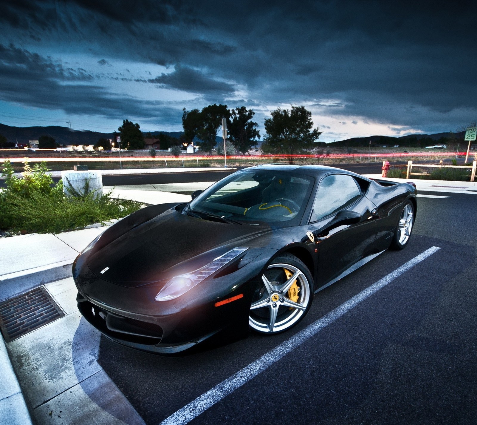 Arafed black sports car parked in a parking lot at night (458, ferrari, roadster)