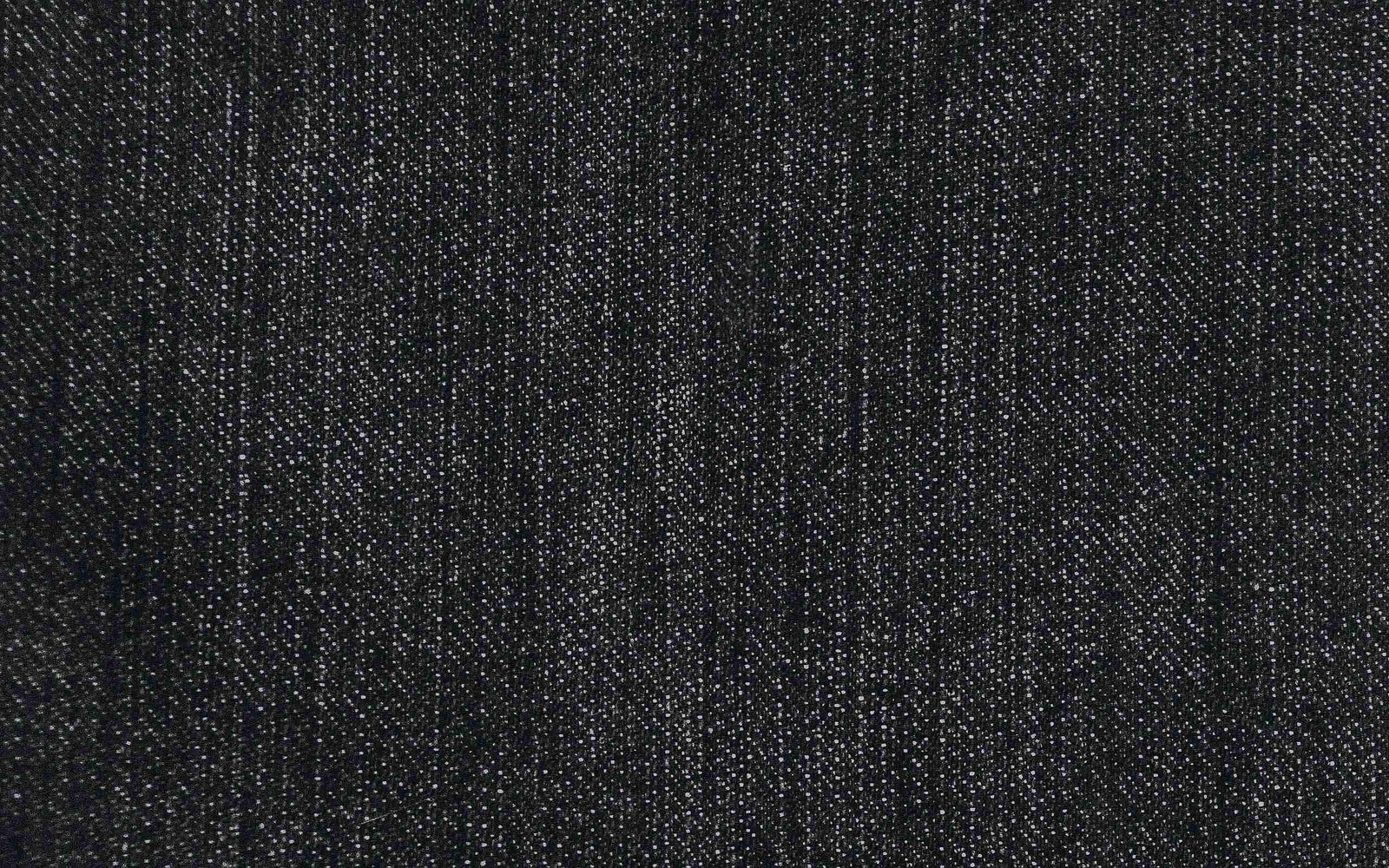 A close up of a black suit with a white tie (woven fabric, linen, black, textile, denim)