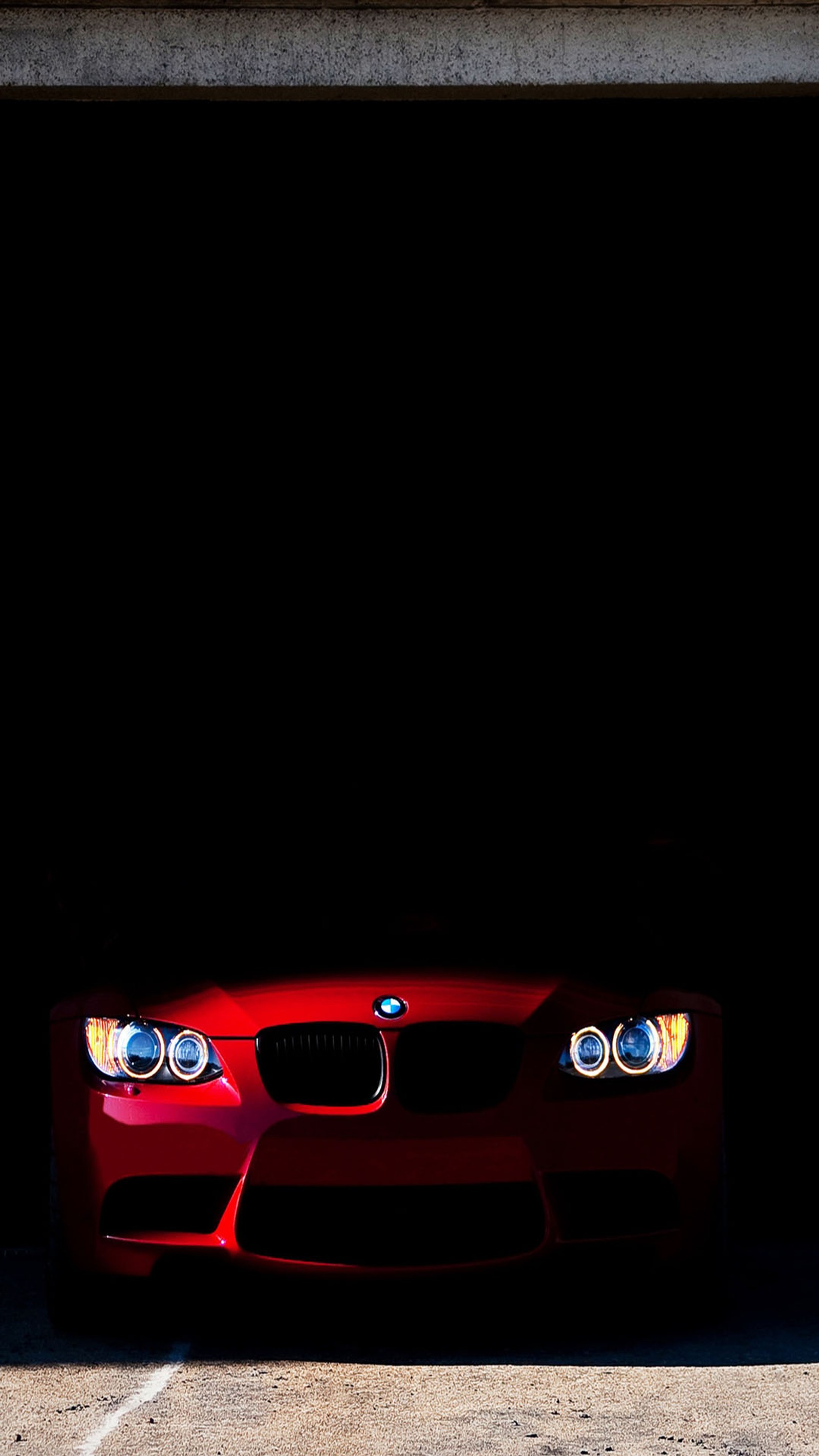 Arafed red sports car parked in a garage with a black background (bmw, red)