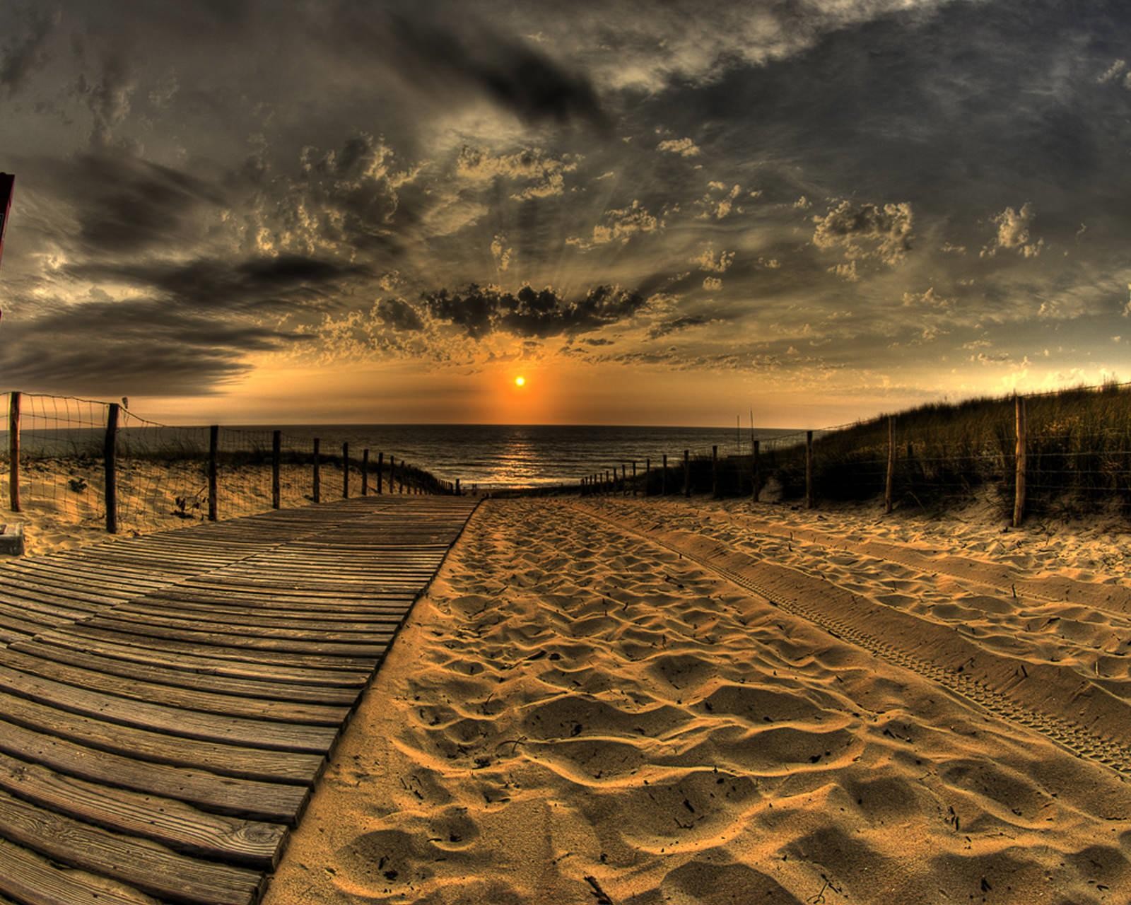 Arafed view of a beach with a wooden walkway leading to the ocean (beautiful, nature, sunet)