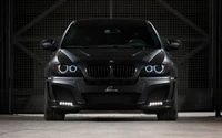 Sleek black BMW SUV with striking headlights, showcasing modern luxury and performance.