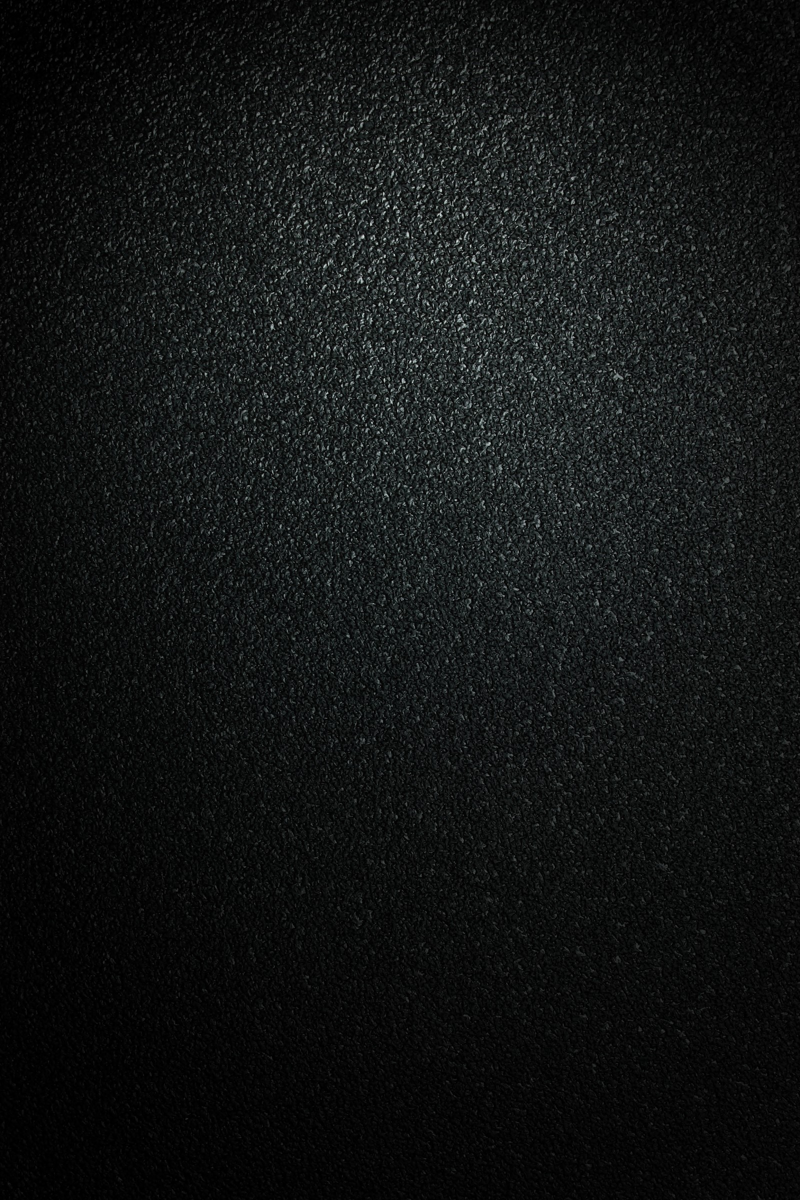 A close up of a black background with a light shining on it (texture, black, darkness, pattern, space)