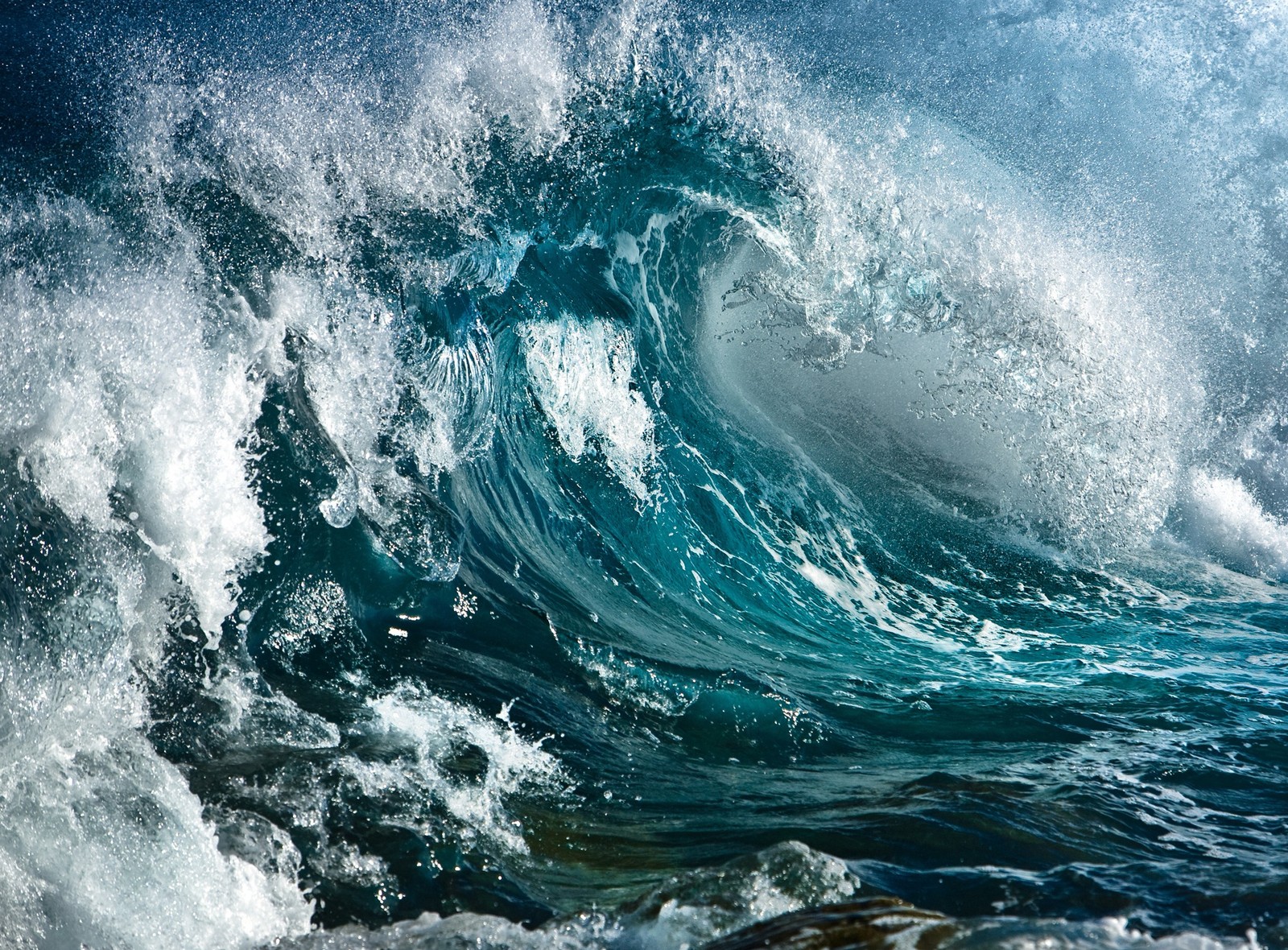 A close up of a large wave in the ocean with a blue sky (sea, stormy, wave)