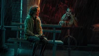 Joaquin Phoenix as Joker Reflects in a Rain-Soaked Moment