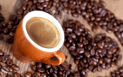 Freshly Brewed Espresso Surrounded by Rich Coffee Beans