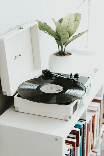 Vintage Phonograph Record Player with Greenery and Books