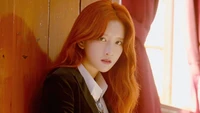 Exy from WJSN showcases her captivating beauty and strong presence in a striking portrait with warm lighting.