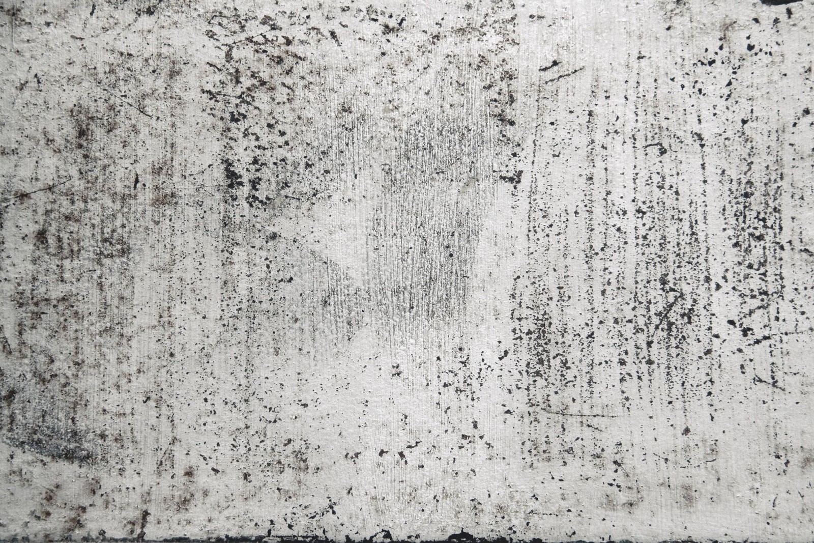 A close up of a dirty wall with a black and white picture (wall, concrete, pattern, transfer, monochrome mode)